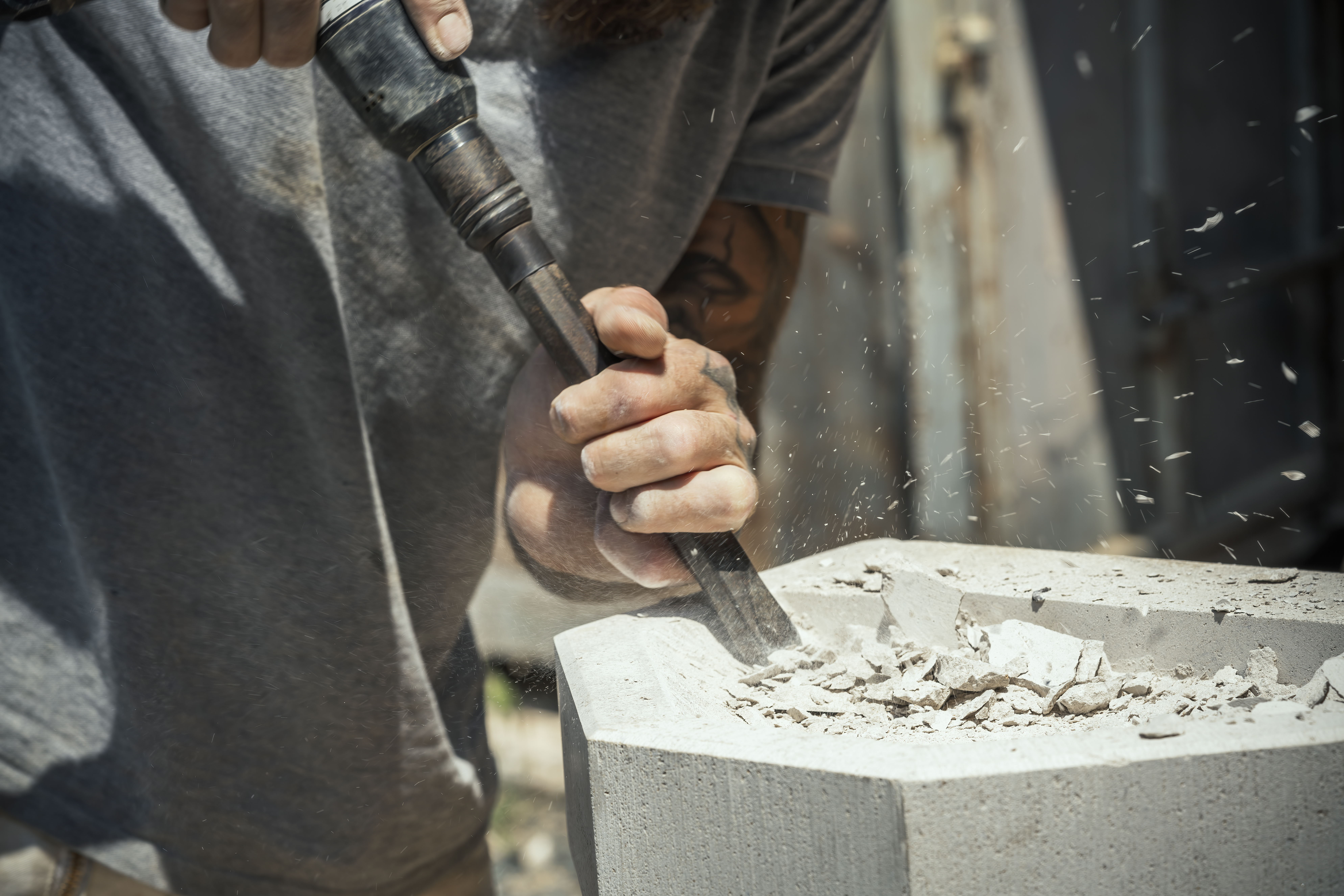 Worker chiseling stone.